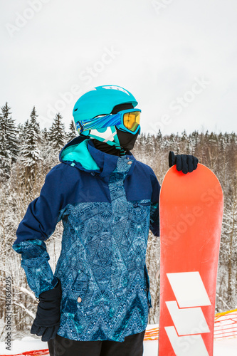 Person with a snowboard on the ski resort photo