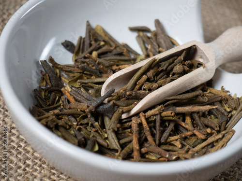 Sagan daila tea leaves close-up in a wooden spoon. Sagan daila Shaman tea, medicinal herbs photo