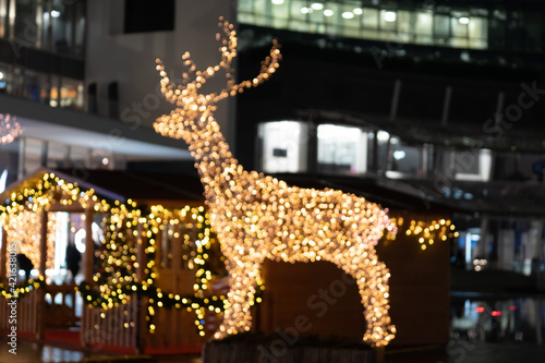 Photography Blurred lights of christmas installation - defocused lights of deer on night city background