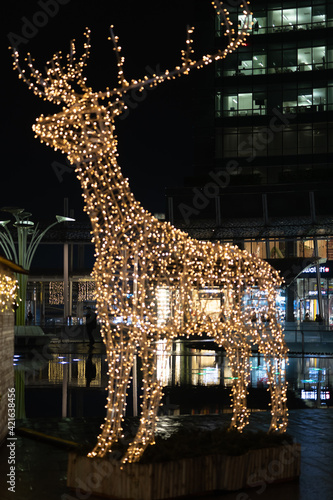 Christmas installation - deer on night city background. Christmas deer installation in Milan, Italy