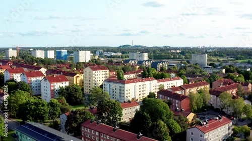 Quiet outskirts of Stockholm, Sweden, Scandinavia. Aerial drone summer flying view of suburb Arsta with tall apartment houses and green trees, park areas.