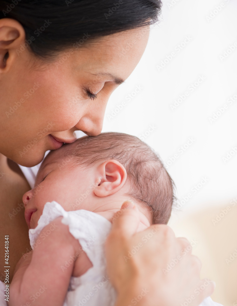 Mother kissing her baby's head Mother kissing her baby's head