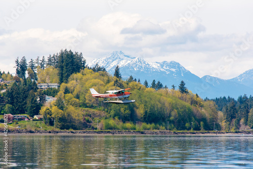 USA, Washington State, Puget Sound. Float plane practicing patterns over Port Orchard Narrows. photo