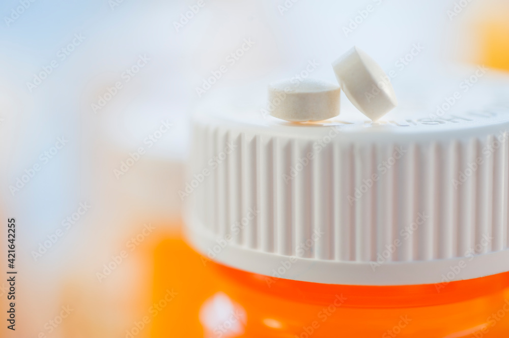 Pills on top of bottle of prescription medication Pills on top of bottle of prescription medication