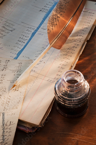 Ink feather pen and ledger