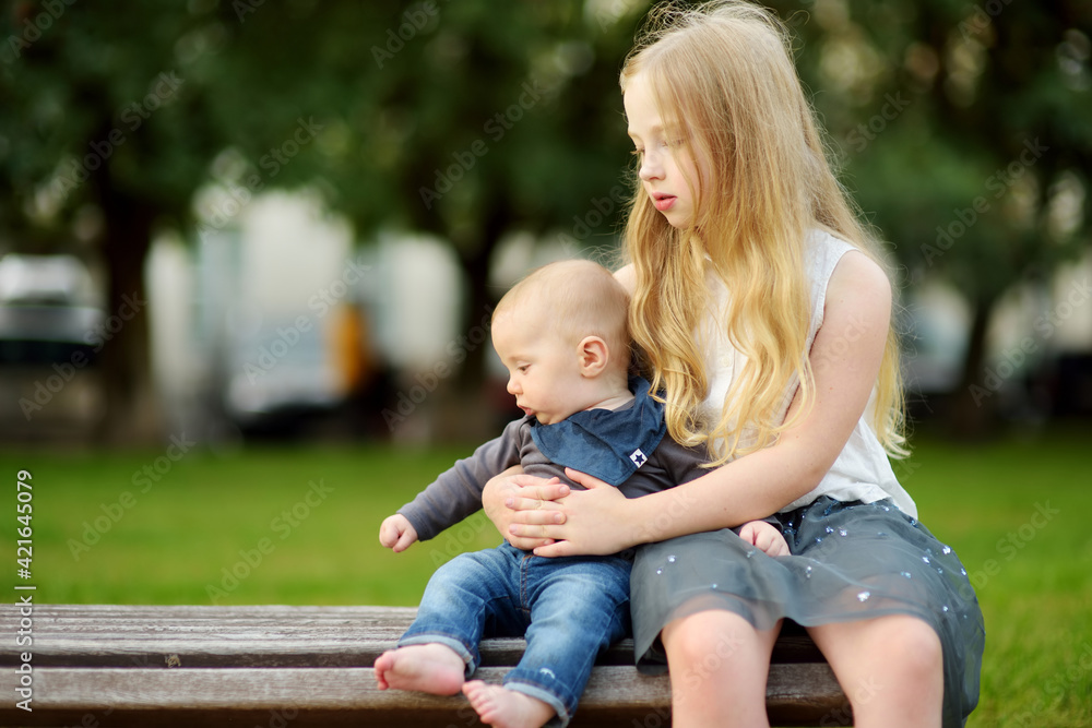 Cute big sister admiring her baby brother. Adorable preteen girl holding  her new baby boy brother. Kids with large age gap. Big age difference  between siblings. Stock-Foto | Adobe Stock