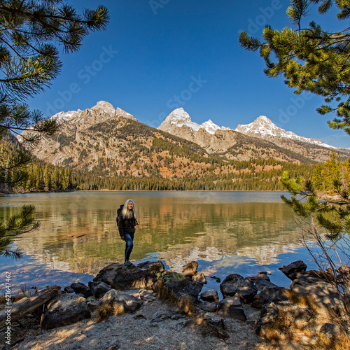 USA, Wyoming, Jackson, Grand Teton National Park, Senior woman standing by Taggart Lake in Grand Teton National Park photo