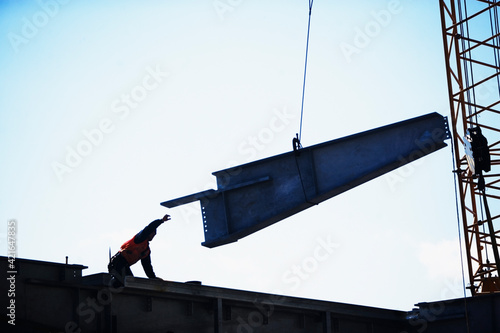 USA, New York City, girder being lifted at construction site