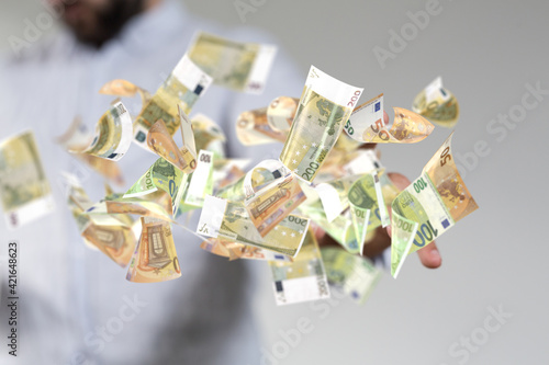 euro bills flying around in hand