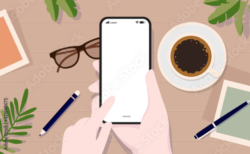 Vector smartphone mockup - Hand using touch screen on device with blank screen, top view angle, and table in background.