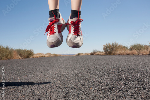 USA, Arizona, Winslow, Human feet in sport shoes jumping photo