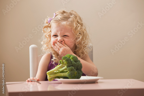 USA, Utah, Lehi, girl (2-3) disgusted with broccoli