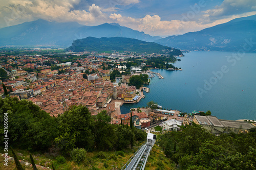 Riva del Garda ,Italy - 07 July 2020: Panoramic view of the beautiful Lake Garda and the Panoramic lift .Riva del Garda town and Garda lake in the autumn time , Trentino Alto Adige region,Italy