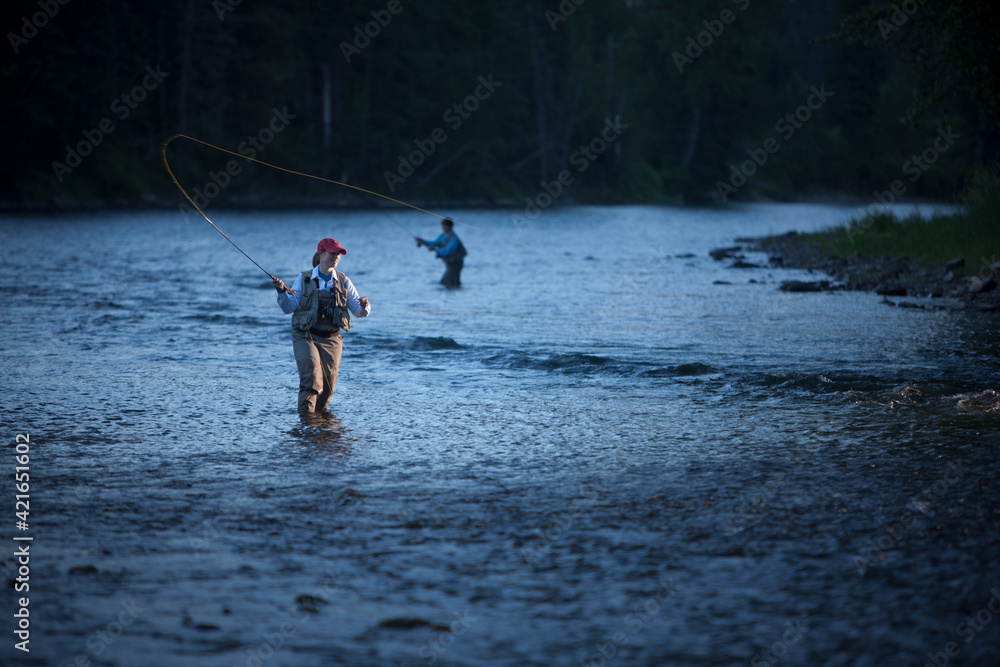 Canada, British Columbia, Fernie, Women fly fishing in river Canada, British Columbia, Fernie, Women fly fishing in river