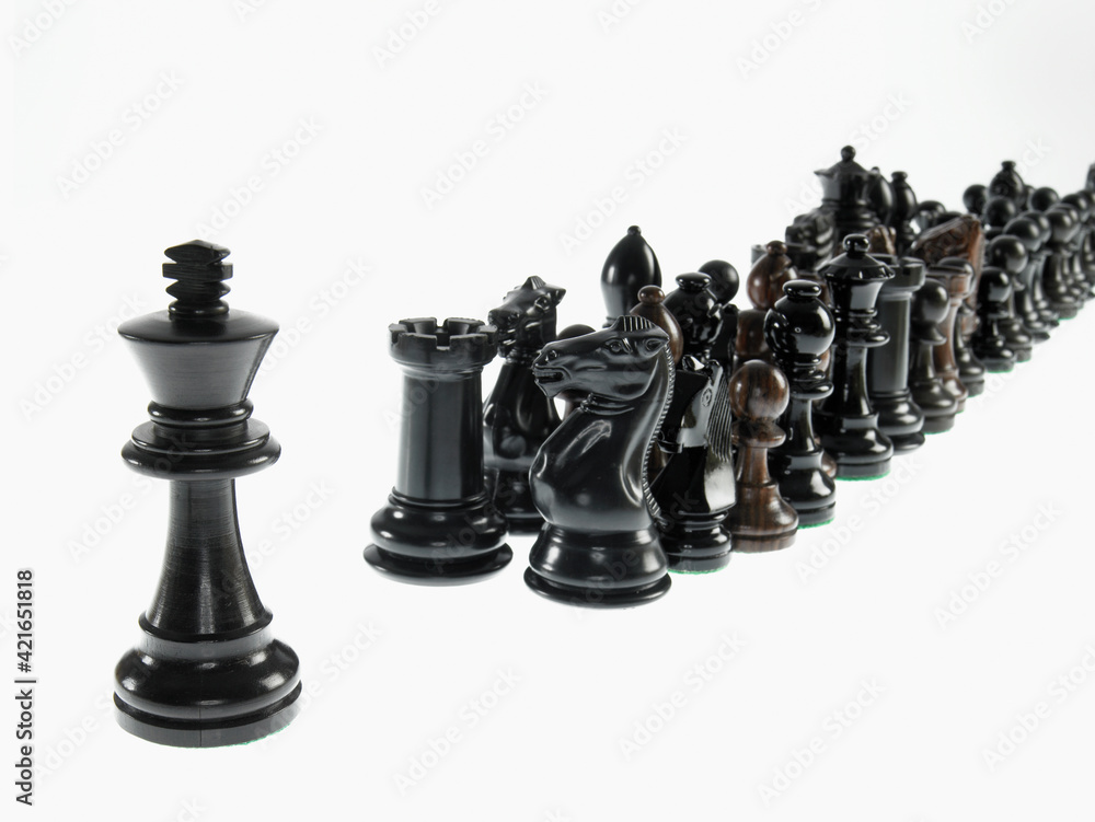 King leading black chess pieces Stock Photo | Adobe Stock