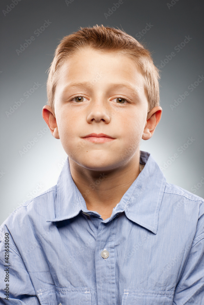 Portrait of boy (8-9) wearing shirt and looking at camera, studio shot Portrait of boy (8-9) wearing shirt and looking at camera, studio shot