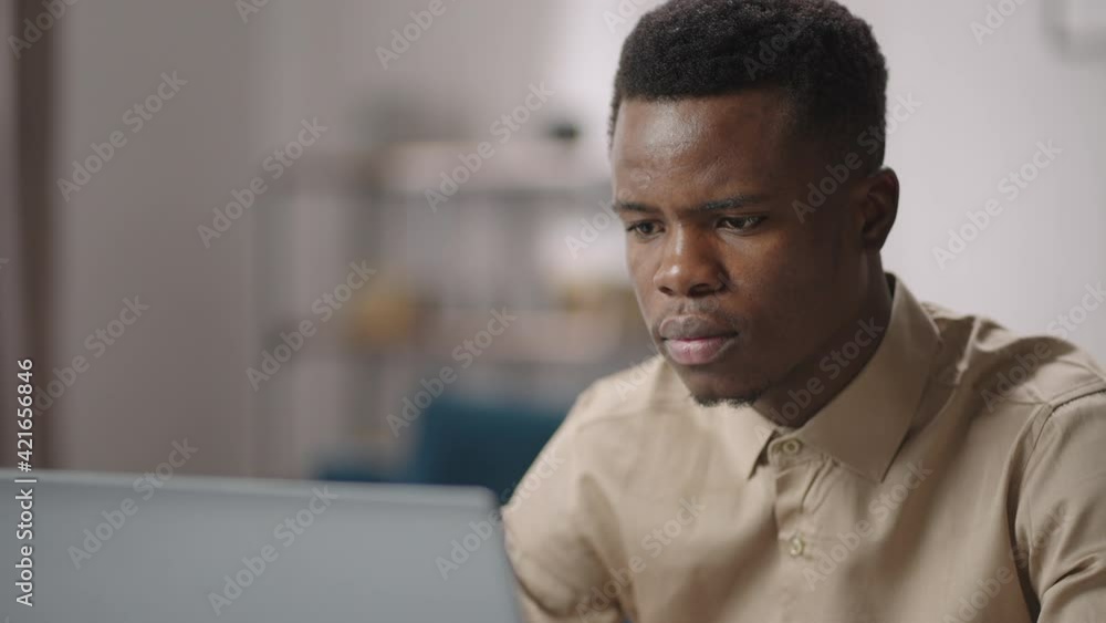black male programmer is viewing on laptop display concentrated, working from home, remote job and freelance black male programmer is viewing on laptop display concentrated, working from home, remote job and freelance