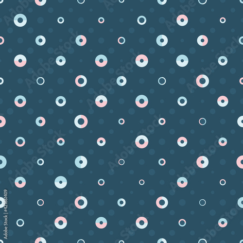 Geometric Polka Dot seamless vector pattern with blue and pink circles and semicircles on dark blue background. Playful stylish texture for wallpaper, wrapping paper and fashion fabrics.