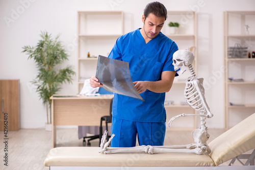 Young male doctor radiologist and skeleton patient in the clinic