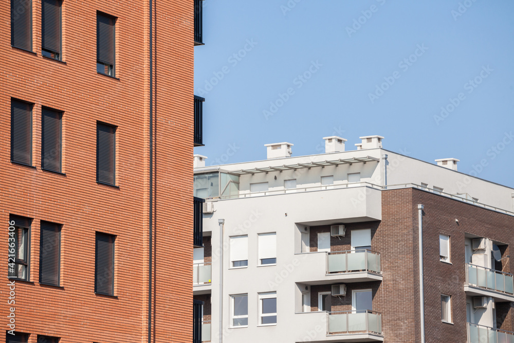 Abstract view of a row of modern apartment buldings, multi stories, with balconies and contemporary equipment. 