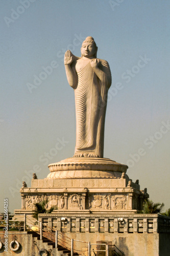 Vertical shot of a Buddha statue on the Hussain Sagar lake in India photo