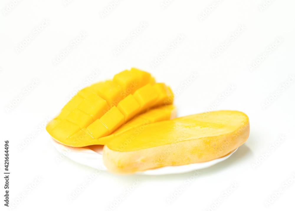 Golden mango slices on a white plate. Golden mango slices on a white plate.