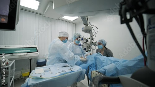 Surgery team making strabismus surgery using modern technologies, latest devices, microscope in modern clinic