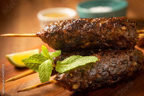 Beef kafta on the wooden board. Kafta, Traditional Arabic cuisine. photo