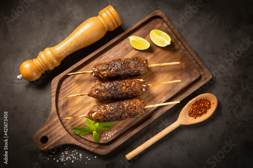 Beef kafta on the wooden board. Kafta, Traditional Arabic cuisine. photo