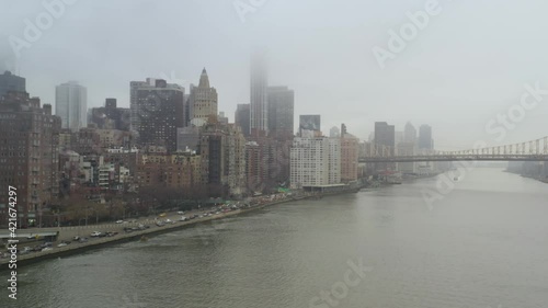 4k Aerial Dolly of NYC East Side Skyline, Bridge and Traffic on rainy day photo