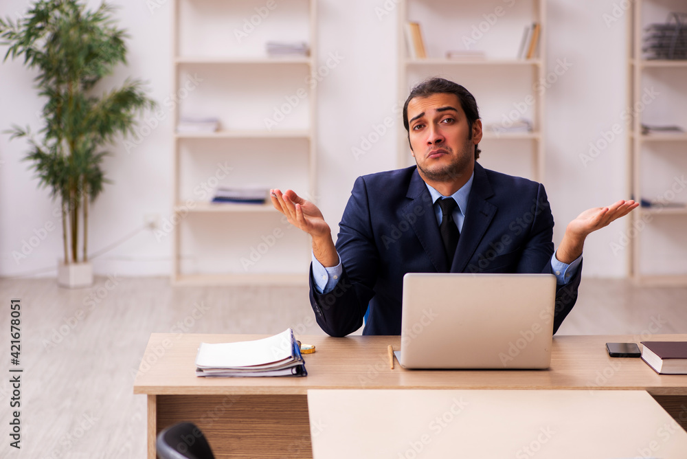 Young male employer sitting in the office Young male employer sitting in the office