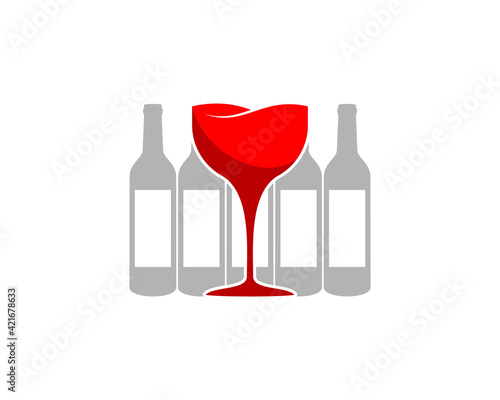 Red wine glass with wine bottle behind