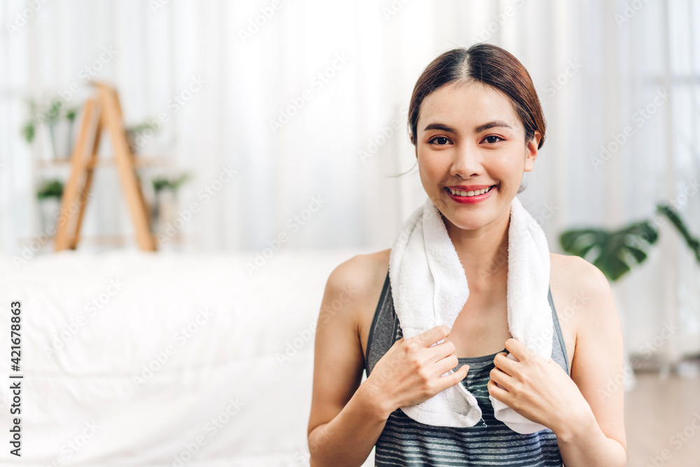 Portrait of sport asian woman in sportswear sitting relax and practicing yoga and do fitness exercise look at camera at home.Diet concept.Fitness and healthy lifestyle Portrait of sport asian woman in sportswear sitting relax and practicing yoga and do fitness exercise look at camera at home.Diet concept.Fitness and healthy lifestyle