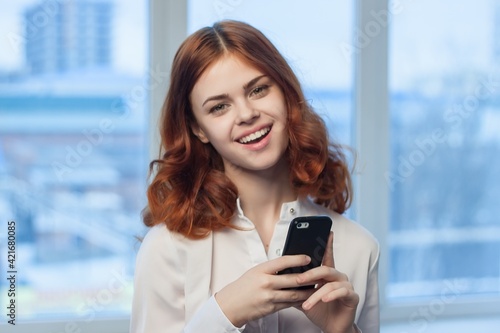 pretty woman in shirt with phone in hand technology professional official