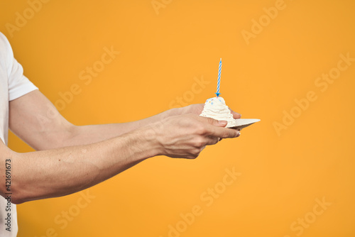 cake with candle celebration birthday decoration yellow background