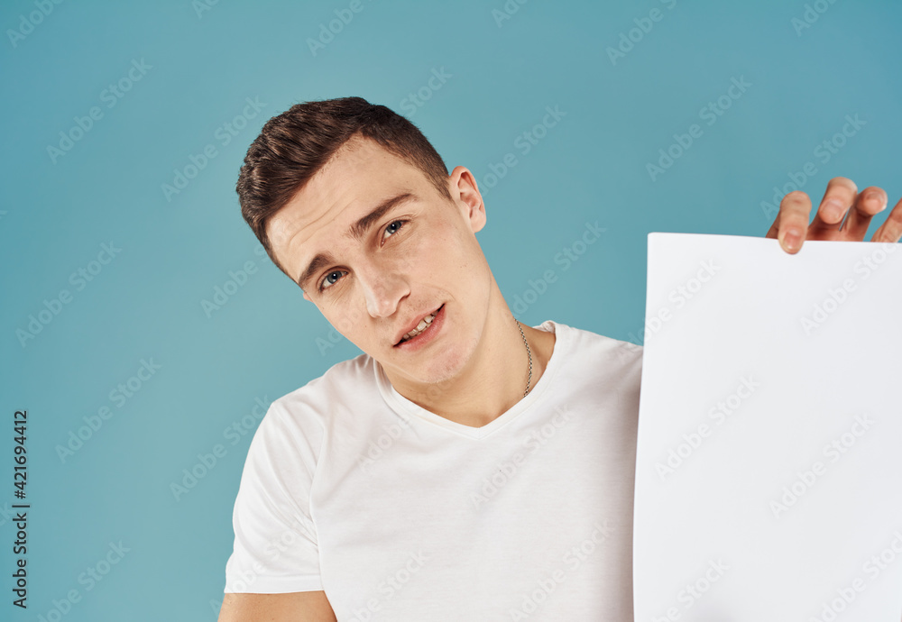 Man Holding Flyer Poster mockup blue background cropped view Man Holding Flyer Poster mockup blue background cropped view