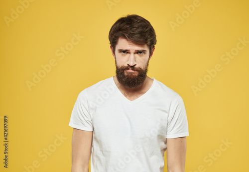 Portrait of handsome man yellow background beard brunette model