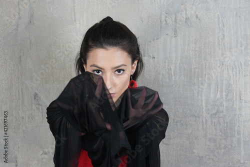 Woman dancer with cloth, face portrait in motion indoors