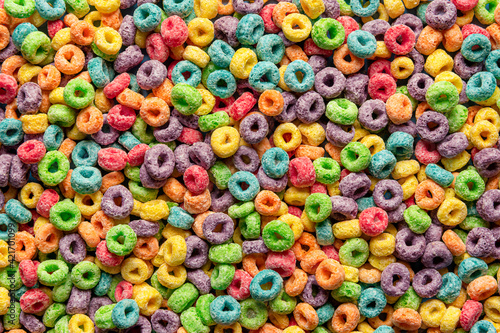 Colorful cereals background. Fruit flavored ring cereals full-frame