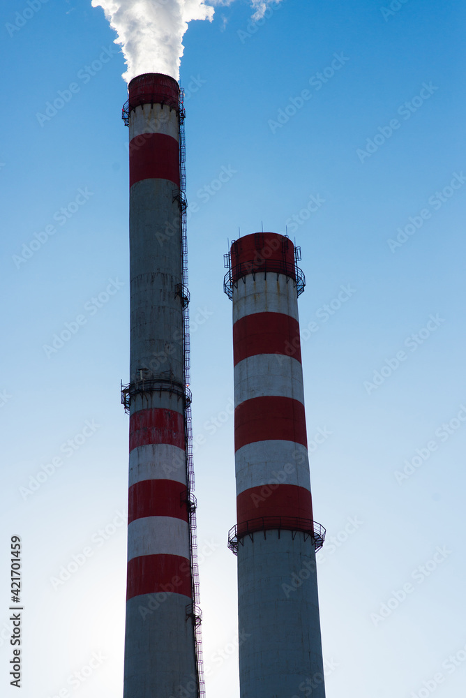 High factory structure and tower crane at industrial production area.