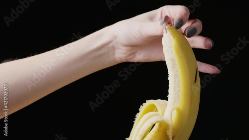Shooting of female hand peeling banana