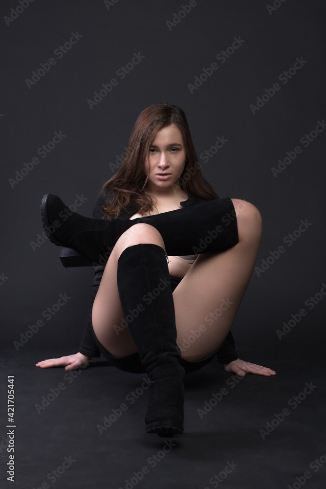 Young brown-haired woman, studio photo on a black background Young brown-haired woman, studio photo on a black background