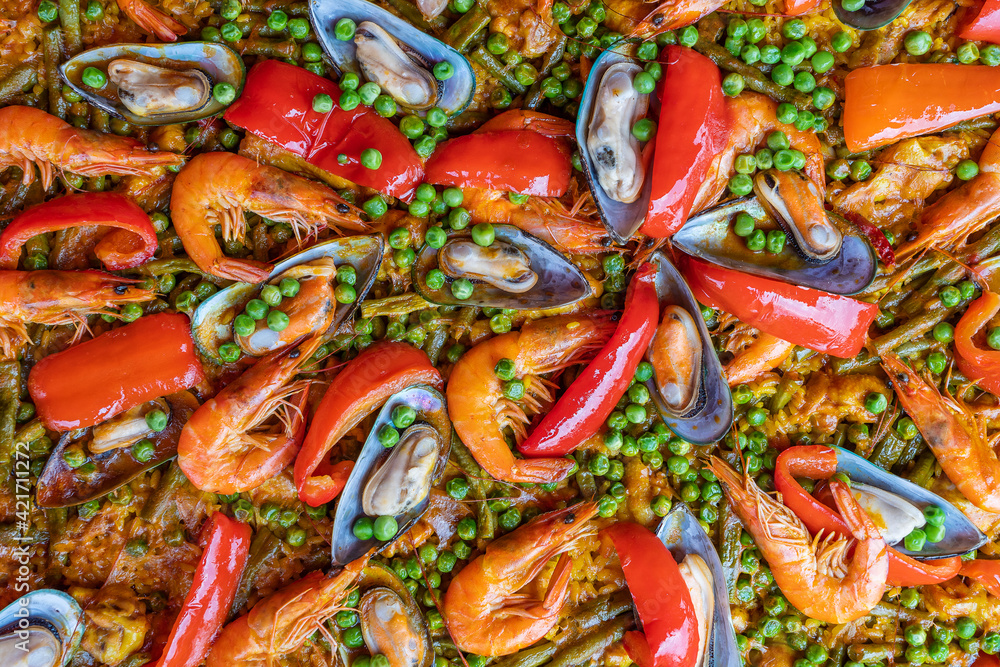 Spanish seafood paella in fry pan with mussels, shrimps and vegetables Spanish seafood paella in fry pan with mussels, shrimps and vegetables