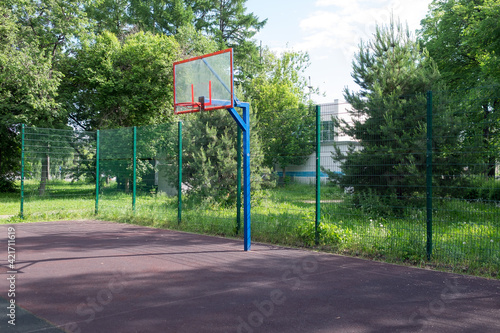 Basketball hoop on the playground. Sports ground in the courtyard of the house.