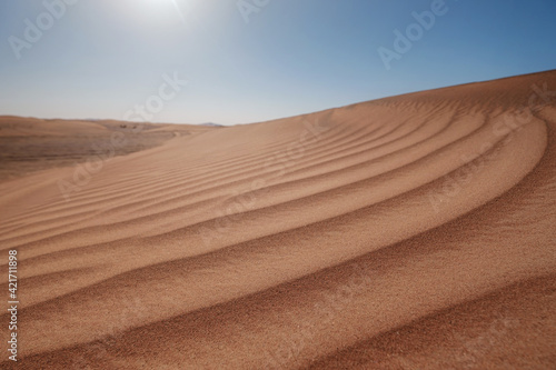 Sunset over the sand dunes in the desert.