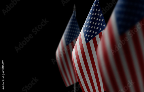 Small national flags of the United States on a black background