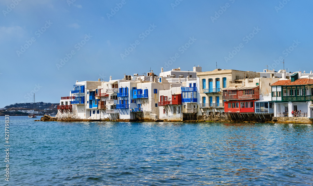 Famous romantic neighbourhood Little Venice of Mykonos main town or Chora, Cyclades, Greece. Whitewashed old fisherman houses on cliffs over sea waves