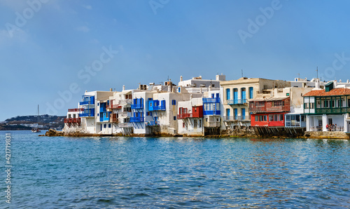 Famous romantic neighbourhood Little Venice of Mykonos main town or Chora, Cyclades, Greece. Whitewashed old fisherman houses on cliffs over sea waves