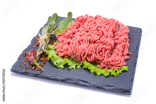 Fresh minced pork and beef and spices on a slate stone.Isolated on a white background, selective focus. horizontal view.