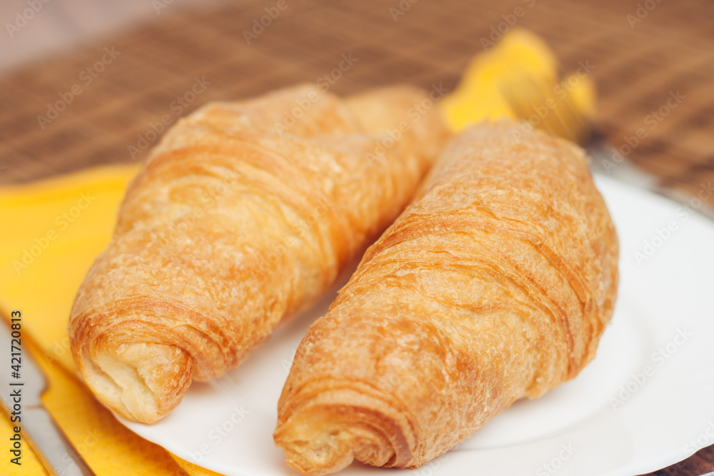 croissants white plates on the table kitchenware a cup croissants white plates on the table kitchenware a cup